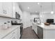 Modern kitchen with white cabinets, stainless steel appliances and center island with sink at 558 Orient Ave, Debary, FL 32713