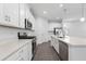 Beautiful kitchen features stainless steel appliances, white cabinets, and an island with quartz countertop at 558 Orient Ave, Debary, FL 32713