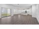 Open concept living room with wood-look floors, a kitchen island, and access to outdoor patio at 558 Orient Ave, Debary, FL 32713