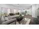 Open concept living space leading into kitchen, with modern furnishings and natural light at 558 Orient Ave, Debary, FL 32713