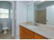 Bathroom featuring wooden cabinets, a sink, toilet, and separate shower room at 5843 Strada Capri Way, Orlando, FL 32835