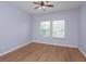 Bedroom with light wood floors and natural light from windows, with ceiling fan at 5843 Strada Capri Way, Orlando, FL 32835