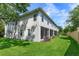 Exterior view of the house featuring a lush green lawn and enclosed outdoor patios at 5843 Strada Capri Way, Orlando, FL 32835