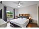 Well-lit bedroom with a large window, sleek furniture, and a comfortable bed at 6001 Westgate Dr # 2124, Orlando, FL 32835
