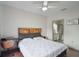 Bright bedroom features a cozy bed, dark wood floors, and a view to the bathroom at 6001 Westgate Dr # 2124, Orlando, FL 32835