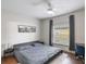Bedroom featuring a gray bed, sleek side tables, and a large window offering natural light at 6001 Westgate Dr # 2124, Orlando, FL 32835