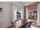 Contemporary dining room featuring a wooden table, black chairs, modern lighting, and large windows at 6001 Westgate Dr # 2124, Orlando, FL 32835