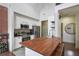 Contemporary kitchen with white cabinets, stainless steel appliances, hardwood countertop and exposed brick at 6001 Westgate Dr # 2124, Orlando, FL 32835