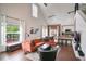 Spacious living room featuring a large comfortable orange sofa and high ceilings with bright natural light at 6001 Westgate Dr # 2124, Orlando, FL 32835