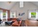 Bright and airy living room with exposed brick, large windows, high ceilings, and hardwood floors at 6001 Westgate Dr # 2124, Orlando, FL 32835