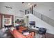 Open-concept living room, kitchen, and dining area with modern finishes, staircase, and hardwood floors at 6001 Westgate Dr # 2124, Orlando, FL 32835