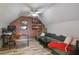Comfortable living room featuring hardwood floors, a brick wall, and a spacious couch at 6001 Westgate Dr # 2124, Orlando, FL 32835