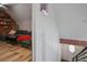 Cozy living room features a comfortable couch, hardwood floors, and exposed brick wall at 6001 Westgate Dr # 2124, Orlando, FL 32835