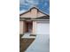 This beautiful home boasts a gray roof, a white garage door, and a peach exterior paint at 602 Hillcrest Dr, Davenport, FL 33897
