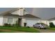 Charming home with a two-car garage, landscaped front yard and a rainbow behind at 602 Hillcrest Dr, Davenport, FL 33897
