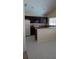 Well-lit kitchen with dark cabinetry, stainless steel microwave, and laminate countertop at 602 Hillcrest Dr, Davenport, FL 33897