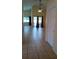 Open-concept living room with sliding glass doors and neutral tile floors at 602 Hillcrest Dr, Davenport, FL 33897