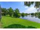 Lush backyard and lake with fountain perfect to enjoy from the screened lanai at 6160 Froggatt St, Orlando, FL 32835