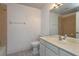 Bathroom featuring a toilet, mirror, vanity and shower with neutral color palette at 6160 Froggatt St, Orlando, FL 32835