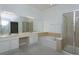Bathroom features a soaking tub, glass shower, double sinks and large mirror at 6160 Froggatt St, Orlando, FL 32835