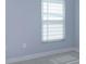 Bedroom featuring a window with blinds and light blue walls at 6160 Froggatt St, Orlando, FL 32835