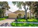 Charming one-story home with a well-manicured lawn, paver driveway, and beautiful landscaping at 6160 Froggatt St, Orlando, FL 32835