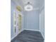 Bright foyer with hardwood floors, chandelier, decorative front door, and high ceilings at 6160 Froggatt St, Orlando, FL 32835