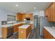 Modern kitchen with stainless steel appliances, a center island, and ample cabinet space at 6160 Froggatt St, Orlando, FL 32835