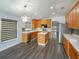 Bright kitchen with a center island, stainless steel appliances, and view to living area at 6160 Froggatt St, Orlando, FL 32835