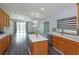 Open kitchen with a center island, stainless steel appliances, and view to living area at 6160 Froggatt St, Orlando, FL 32835