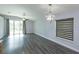 Living room area featuring hardwood floors, natural light, and modern light fixture at 6160 Froggatt St, Orlando, FL 32835
