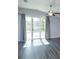 Living room showcasing hard surface floors and sliding glass doors to the back yard at 6160 Froggatt St, Orlando, FL 32835