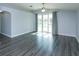 Spacious living room featuring hard surface floors and sliding glass doors to outdoor view at 6160 Froggatt St, Orlando, FL 32835