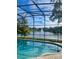 Backyard screened pool with lake view provides tranquility and relaxation at 6160 Froggatt St, Orlando, FL 32835