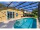 Inviting screened-in pool area with brick paver deck, perfect for relaxing and entertaining at 6160 Froggatt St, Orlando, FL 32835