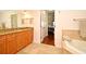 Bright bathroom featuring double sinks, tiled floors, and a bathtub at 630 Vassar St # 2508, Orlando, FL 32804