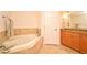 Bathroom featuring a soaking tub, granite counters, and tiled floors at 630 Vassar St # 2508, Orlando, FL 32804