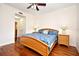 Comfortable bedroom featuring hardwood floors, ceiling fan, and two nightstands at 630 Vassar St # 2508, Orlando, FL 32804