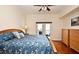 Bright bedroom with a ceiling fan, access to a balcony, and hardwood floors at 630 Vassar St # 2508, Orlando, FL 32804
