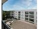 View of the building's exterior with balconies, courtyard, and greenery at 630 Vassar St # 2508, Orlando, FL 32804