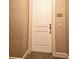 View of the unit's front door, number 2508, featuring neutral-toned wall coverings and a glimpse of the carpet at 630 Vassar St # 2508, Orlando, FL 32804