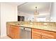 Kitchen with granite countertops, stainless steel appliances, and wood cabinets at 630 Vassar St # 2508, Orlando, FL 32804