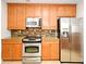 Modern kitchen featuring stainless steel appliances, granite counters, and light wood cabinets at 630 Vassar St # 2508, Orlando, FL 32804