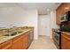 Well-lit kitchen featuring stainless steel appliances, granite counters, and light wood cabinetry at 630 Vassar St # 2508, Orlando, FL 32804
