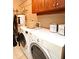 Functional laundry room equipped with a washer, dryer, and storage cabinets at 630 Vassar St # 2508, Orlando, FL 32804