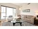 Bright living area showcasing a comfortable sectional, glass table, and a large window for natural light at 630 Vassar St # 2508, Orlando, FL 32804