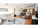 Open concept living room with a dining area and kitchen in the background, featuring hardwood floors at 630 Vassar St # 2508, Orlando, FL 32804