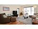 Cozy living room featuring modern furnishings, a large window, and a stylish rug on wood floors at 630 Vassar St # 2508, Orlando, FL 32804