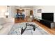 Spacious living room featuring hardwood floors and an open layout to the kitchen and dining areas at 630 Vassar St # 2508, Orlando, FL 32804