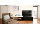 Relaxing living room setup with an armchair, a large television, and access to an outdoor balcony at 630 Vassar St # 2508, Orlando, FL 32804